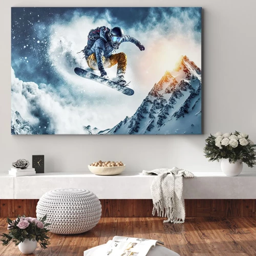 Obraz na płótnie - Ekstremalne emocje - Snowboardzista w locie nad ośnieżonymi górami - 70x50cm